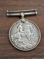 Front side of the WWI Silver War Medal showing Saint George on horseback and dates 1914 and 1918.