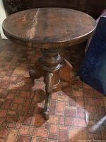 Top view of round solid wood seat with visible wear and aging marks.