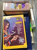 Top view showing Loupe brand box with French text and small brush container