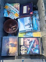 Open bin view showing assorted CDs, DVDs, and assorted media items overlapping with collection of books and patches