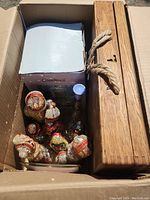 Box containing the wooden lockable box, Avon bottle, Cardinal clock box, and collectible figurines.