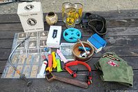 Overview photo showing a variety of items including mugs, collectible cards, Pez dispensers, pint glasses, ceramic pot, hat, and other items arranged on a wooden surface.