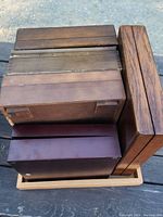 Top view of wood boxes arranged inside a wood tray to show sizes and shapes.
