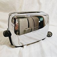 Front and side view showing shiny chrome finish with wave pattern and black plastic side lever.