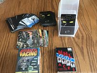 Overview of three groups of cards - unopened NHL Bicycle cards, Andretti Racing cards in taped box, Bionicle cards in plastic case and laid out