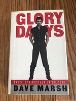 Front cover of the hardcover book showing Bruce Springsteen standing in black against a white background with bold red and gray text 'Glory Days' by Dave Marsh.