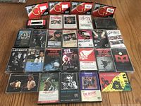Top view of all tapes, showing 4 unopened JVC GP 60 blank tapes on top and various rock artist albums below.