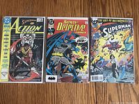 Three DC Comics including Superman Action Comics Annual #4, Batman Detective Comics #622, and Superman The World of Metropolis #1, all with vivid cover illustrations and good condition.