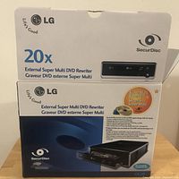Box of LG External Super Multi DVD Rewriter displaying brand, model GE20 and 20x speed with SecurDisc technology.
