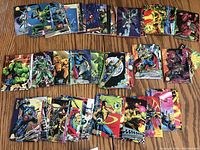 Spread of assorted Marvel trading cards showing various superheroes in colorful comic-style artwork.
