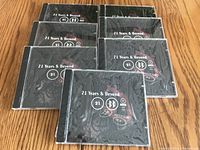 Seven sealed CDs titled '21 Years & Beyond' with black cover and white text.