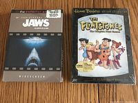 Front view of Jaws 30th Anniversary DVD set and The Flintstones Season 1 DVD box set, sealed in original packaging.
