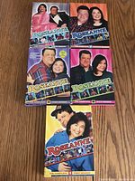 Photo of five Roseanne DVD season sets Seasons 1 to 5, showing colorful cover art with main cast photos.