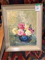 Frontal photo of the framed acrylic painting showing floral bouquet and grapes in a blue vase on a textured background.