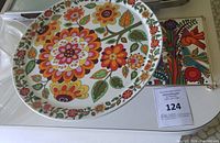 Large round pedestal cake stand with colorful floral pattern