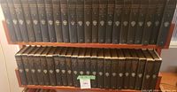 Two shelves holding dark cloth-bound Harvard Classics volumes