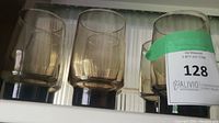 Six tawny colored Dominion glasses arranged in two rows, showing the thick bases and smooth translucent walls.