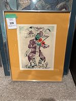 Full view of framed artwork leaning against wall showing mat, frame and print image of violinist.