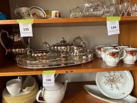 Wide view including silver tea set and Royal Albert cups and saucers with floral pattern