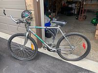 Full side view of the Twister Super Cycle men's bike showing frame, tires, saddle, and handlebars with mounted headlight.