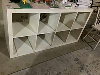 Front view of white shelving unit showing 10 square open compartments.