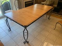 Full-length view of table showing wood veneer top and metal frame