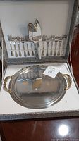 Overall image of dessert service set with cake plate, utensils including 8 forks, serving knife and cake server stored in a case.