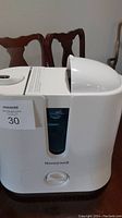 Front view of the Honeywell cool mist humidifier with water level window and control knob, white plastic body.