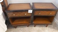 Pair of solid wood night stands side by side showing overall shape, drawer with diamond pattern, and open shelf area