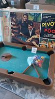 Vintage Milton Bradley Pivot Pool 1970s boxed game with players shown on box art, includes game components on table beside box