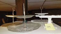 Photo showing three different cake stands: white milk glass with beaded edges, clear glass with floral etch, gold patterned plates with gold handle.