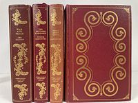Front and spine view of four leather bound classic literature books with gold embossed detailing.