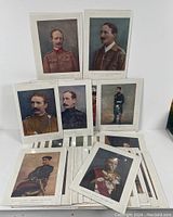 Overview of assorted military portraits laid out and shrink-wrapped, including multiple officers' portraits with distinct early 1900s uniforms and facial hair styles.