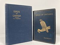 Front covers of both books, Birds of Canada and Birds of Ontario, showing titles in gold embossing on blue cloth covers.
