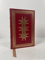 Front cover of the book showing red full leather cover with gold embossing.