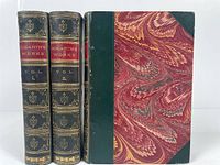 Front view of Hogarth's Works volumes I, II, and III with distinct marbled covers and leather spines showing titles and gold decorations