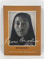 Front cover showing the title 'Reva Brooks photographs' with a black and white photo of a woman and names of compilers