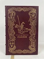 Front cover of the leather bound Ivanhoe book showing detailed gold embossed knight and heraldic designs.