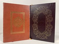 Front cover and back cover of two Easton Press leather bound books showing embossed gold ornamental designs.