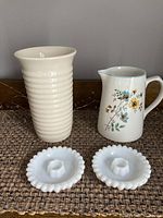 Photo showing all items: cream ribbed vase, floral Lord Nelson jug, two milk glass candle holders