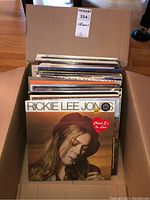 Box filled with various vinyl albums, front one is Rickie Lee Jones album.