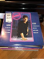 Photo of Cocktail film soundtrack record album front cover with artists and band names listed.