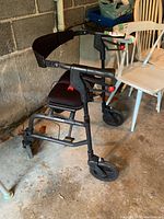 Side angle view of Nexus rollator walker showing padded seat, backrest, handle brakes, and wheels.