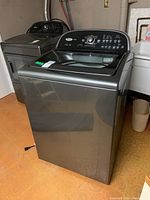 Front and side view of dark gray Whirlpool Cabrio washer showing overall condition