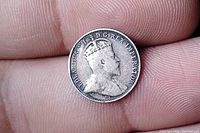Close-up photo of the obverse side of the silver coin showing King Edward VII portrait and legend