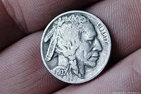 Obverse side of 1937 Buffalo Nickel showing Native American profile and date 1937.