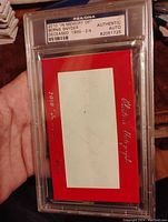 Front of the slabbed autograph card showing the red and white card with Bernie Snyder's signature and PSA certification label.