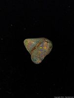 Polished triangular multi-color raw Australian opal on black background showing vibrant play of colors and natural rough sections.