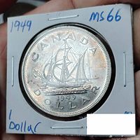 Reverse side of the 1949 Canadian Newfoundland silver dollar featuring the sailing ship design, date, and denomination.