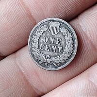 Reverse side showing shield above 'ONE CENT' and laurel wreath.